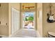 Bright entryway with open doors revealing a courtyard and a guitar at 30349 Fairway Dr, Wesley Chapel, FL 33543