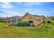 Back of house with lush landscaping, a pool enclosure, and a spacious yard at 30349 Fairway Dr, Wesley Chapel, FL 33543