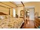 Main bedroom with a four poster bed and ensuite bathroom at 30349 Fairway Dr, Wesley Chapel, FL 33543