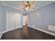 Simple bedroom with double door closet and dark flooring at 10926 Sailbrooke Dr, Riverview, FL 33579