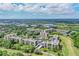 Aerial view of a condo community with a pool and lush landscaping near a golf course and waterway at 800 Cove Cay Dr # 3C, Clearwater, FL 33760