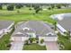 Property view with double garage and landscaping at 657 Masterpiece Dr # 154, Sun City Center, FL 33573