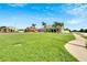 Gray house with palm trees, green lawn, and sidewalk at 1905 Via Napoli St, Plant City, FL 33566