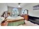 Bedroom with wooden furniture and a large window at 1905 Via Napoli St, Plant City, FL 33566