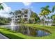 Exterior view of building with pond and landscaping at 1030 Bellasol Way # 201, Apollo Beach, FL 33572