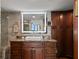 Modern bathroom with dark wood cabinets and a large mirror at 5153 Isla Key S Blvd # 412, St Petersburg, FL 33715