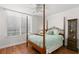 Bedroom with hardwood floors, a four-poster bed, and a window at 5153 Isla Key S Blvd # 412, St Petersburg, FL 33715