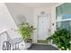 Inviting condo entrance with plants and outdoor seating at 5153 Isla Key S Blvd # 412, St Petersburg, FL 33715