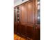 Well-organized pantry with ample wooden cabinetry and glass-front doors at 5153 Isla Key S Blvd # 412, St Petersburg, FL 33715