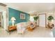 Living room with teal walls, tiled floors, and ample natural light at 6515 Los Altos Way, Tampa, FL 33634