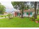 Ranch-style home with teal accents, a porch, and a landscaped yard at 6515 Los Altos Way, Tampa, FL 33634