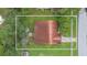 Aerial view of single story home with red tile roof, driveway and large yard at 6515 Los Altos Way, Tampa, FL 33634