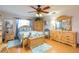 Main bedroom with wood dresser and ceiling fan at 6515 Los Altos Way, Tampa, FL 33634