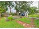 Backyard with shed, trees, and brick pathway at 6515 Los Altos Way, Tampa, FL 33634