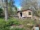 Distressed property needing complete renovation; overgrown lot at 17025 Dalberg Dr, Spring Hill, FL 34610