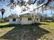 Simple, one-story house with large trees and grassy yard at 17025 Dalberg Dr, Spring Hill, FL 34610
