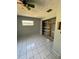 Bedroom with tiled floors and a closet; requires general repairs and updates at 17025 Dalberg Dr, Spring Hill, FL 34610