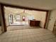 Open living area with wood beams and a view into the kitchen at 17025 Dalberg Dr, Spring Hill, FL 34610