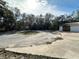Large cracked driveway and surrounding yard at 17025 Dalberg Dr, Spring Hill, FL 34610