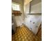 A laundry room with a water heater and cabinets at 17025 Dalberg Dr, Spring Hill, FL 34610