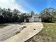 White garage with roll-up door and additional storage at 17025 Dalberg Dr, Spring Hill, FL 34610