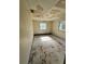 A simple bedroom with worn flooring and a window at 17025 Dalberg Dr, Spring Hill, FL 34610