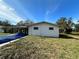 Small house with covered carport and partially visible pool at 17025 Dalberg Dr, Spring Hill, FL 34610