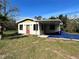 House exterior with red door and covered patio at 17025 Dalberg Dr, Spring Hill, FL 34610