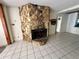 Large stone fireplace in a living area with tile flooring at 17025 Dalberg Dr, Spring Hill, FL 34610
