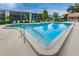 Community pool with plenty of lounge chairs at 1450 Heather Ridge Blvd # 107, Dunedin, FL 34698