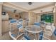 Community pool area with tables and chairs at 1450 Heather Ridge Blvd # 107, Dunedin, FL 34698