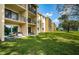 Building exterior showcasing a well-maintained lawn at 1450 Heather Ridge Blvd # 107, Dunedin, FL 34698
