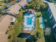 Aerial view of community pool, spa, and shuffleboard at 1450 Heather Ridge Blvd # 107, Dunedin, FL 34698