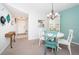 Charming dining area with a round table, colorful chairs, and a display cabinet at 1450 Heather Ridge Blvd # 107, Dunedin, FL 34698