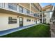 Exterior view of building with walkway and landscaping at 1450 Heather Ridge Blvd # 107, Dunedin, FL 34698