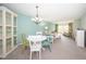 Bright dining area with table and chairs, showcasing a light and airy atmosphere at 1450 Heather Ridge Blvd # 107, Dunedin, FL 34698