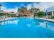 Inviting community pool with a large patio at 1450 Heather Ridge Blvd # 107, Dunedin, FL 34698