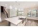 Large kitchen island with white quartz countertop and farmhouse sink at 4807 Lago Vista Cir, Land O Lakes, FL 34639