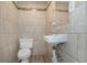 Small half bathroom with updated tile at 906 Jurgens St, Clearwater, FL 33755