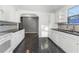 Spacious kitchen featuring white cabinets, granite countertops, and black tile floors at 906 Jurgens St, Clearwater, FL 33755