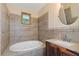 Bathroom with soaking tub and tile surround at 906 Jurgens St, Clearwater, FL 33755