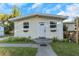 House exterior with a white door, landscaping, and walkway at 906 Jurgens St, Clearwater, FL 33755