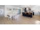 Bright dining area with white table, bench, and view to the kitchen at 229 Tallahassee Ne Dr, St Petersburg, FL 33702