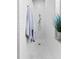 Clean bathroom with a long shower, white tile, and penny round floor at 15212 Kestrelrise Dr, Lithia, FL 33547