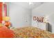 Relaxing bedroom with patterned bedding, nightstand and orange accents at 15212 Kestrelrise Dr, Lithia, FL 33547