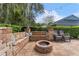 Cozy fire pit with built-in seating and tranquil setting at 15212 Kestrelrise Dr, Lithia, FL 33547