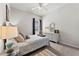 Bright bedroom featuring a comfortable bed, nightstand, and soft carpeting at 15212 Kestrelrise Dr, Lithia, FL 33547