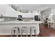 Modern kitchen with white cabinets, granite countertops, and a large island with seating at 15212 Kestrelrise Dr, Lithia, FL 33547