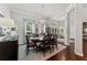 Bright dining room with hardwood floors, a round dining table, and views to the entryway at 15212 Kestrelrise Dr, Lithia, FL 33547