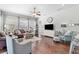 Open living space with hardwood floors, comfortable seating, and a large TV at 15212 Kestrelrise Dr, Lithia, FL 33547